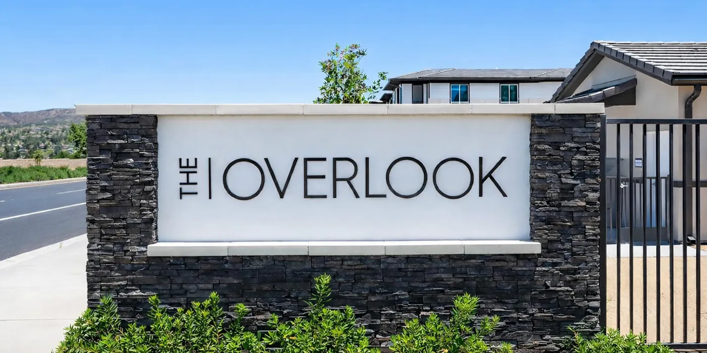 The Overlook wordmark and visual identity applied to a hilltop apartment community