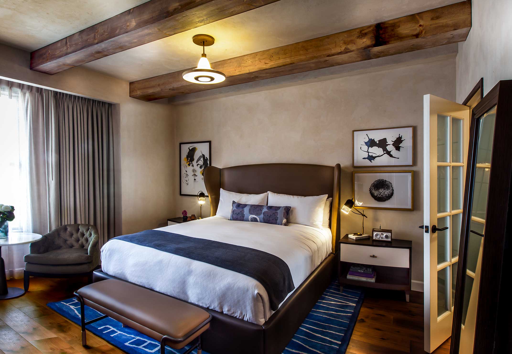 Hotel Figueroa guest room with custom bed and fig-leaf wallcovering