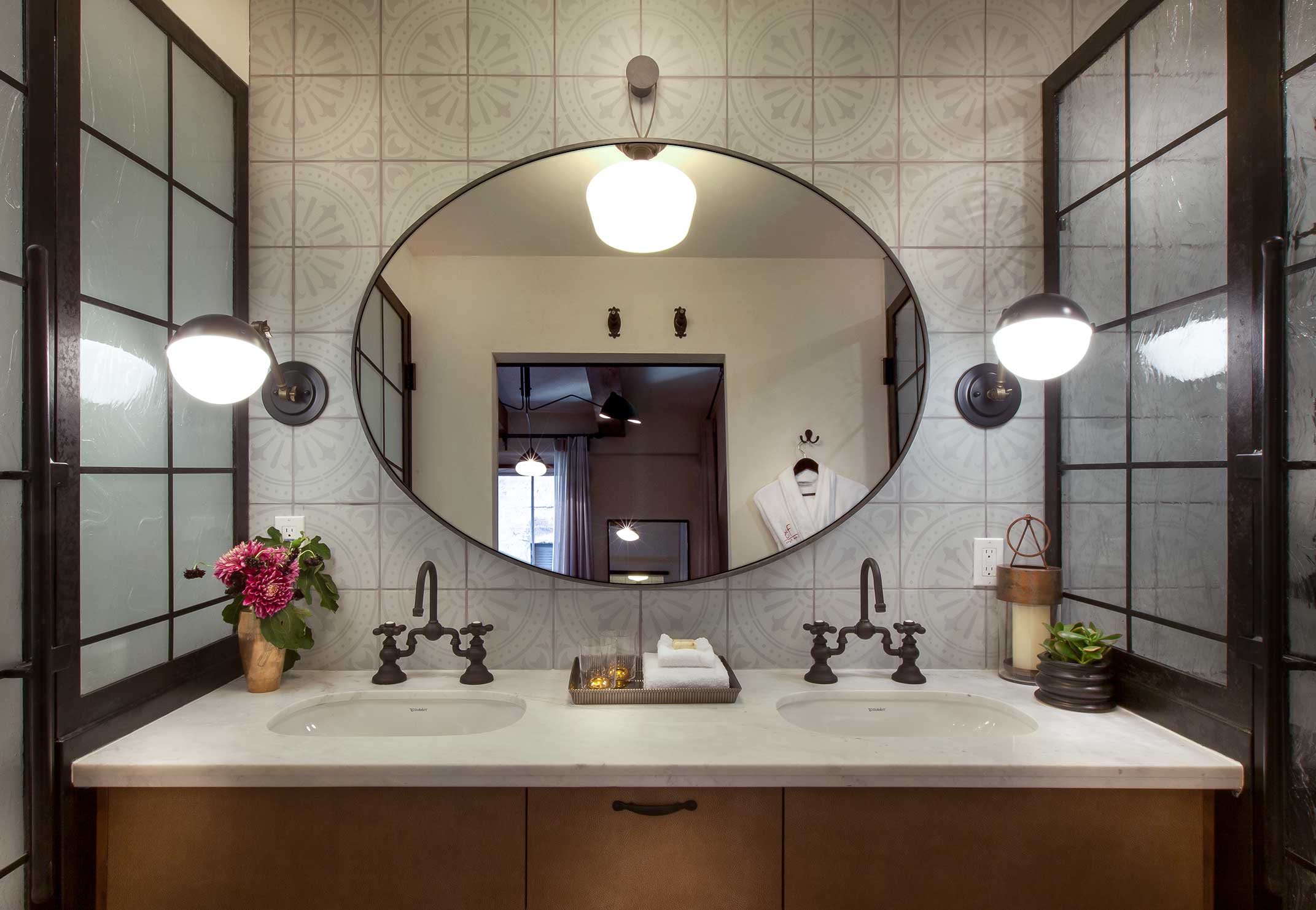 Hotel Figueroa bathroom vanity with warm plaster walls and brass details